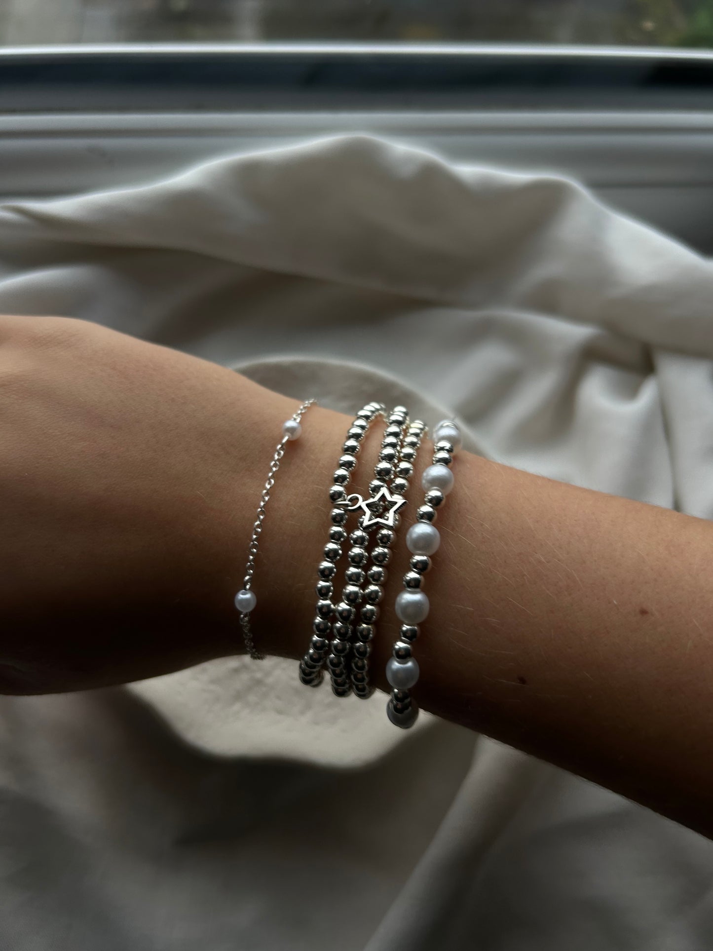 silver chain and pearl bracelet