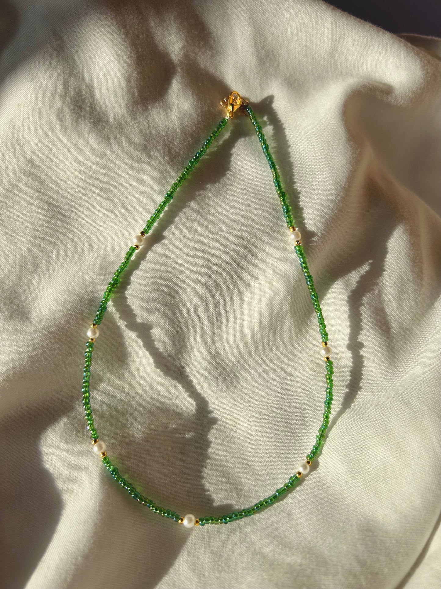 Green beaded necklace with pearl beads