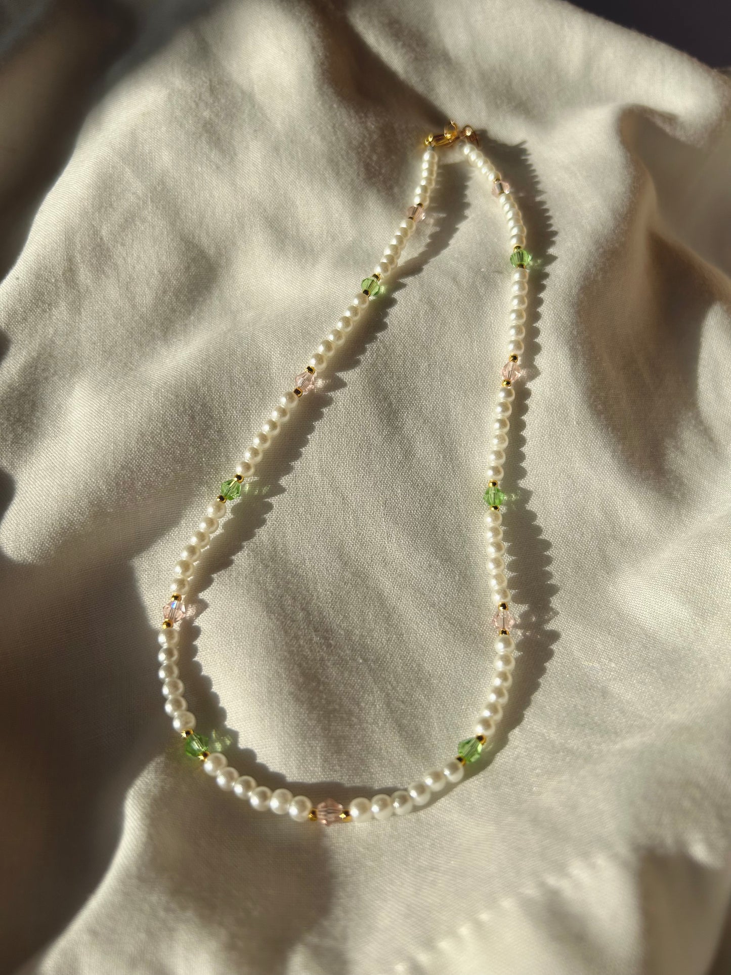 Pearl necklace with pink and green crystal beads